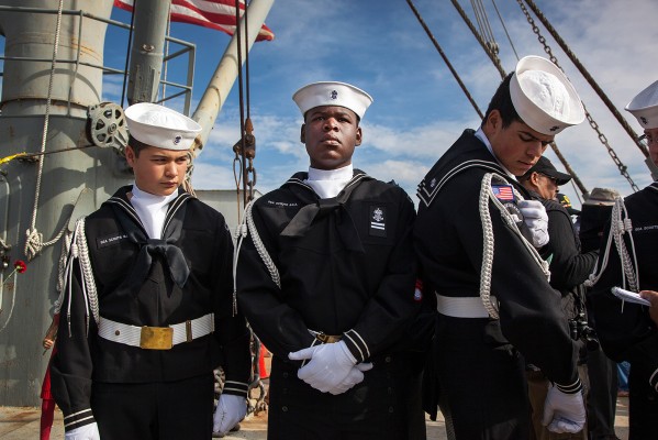 Sea Scouts Art Carrion, Dennis Metoyer and Quentin Levin stand in uniform on the deck of the SS Red Oak Victory. (Photo by: Mark Andrew Boyer)
